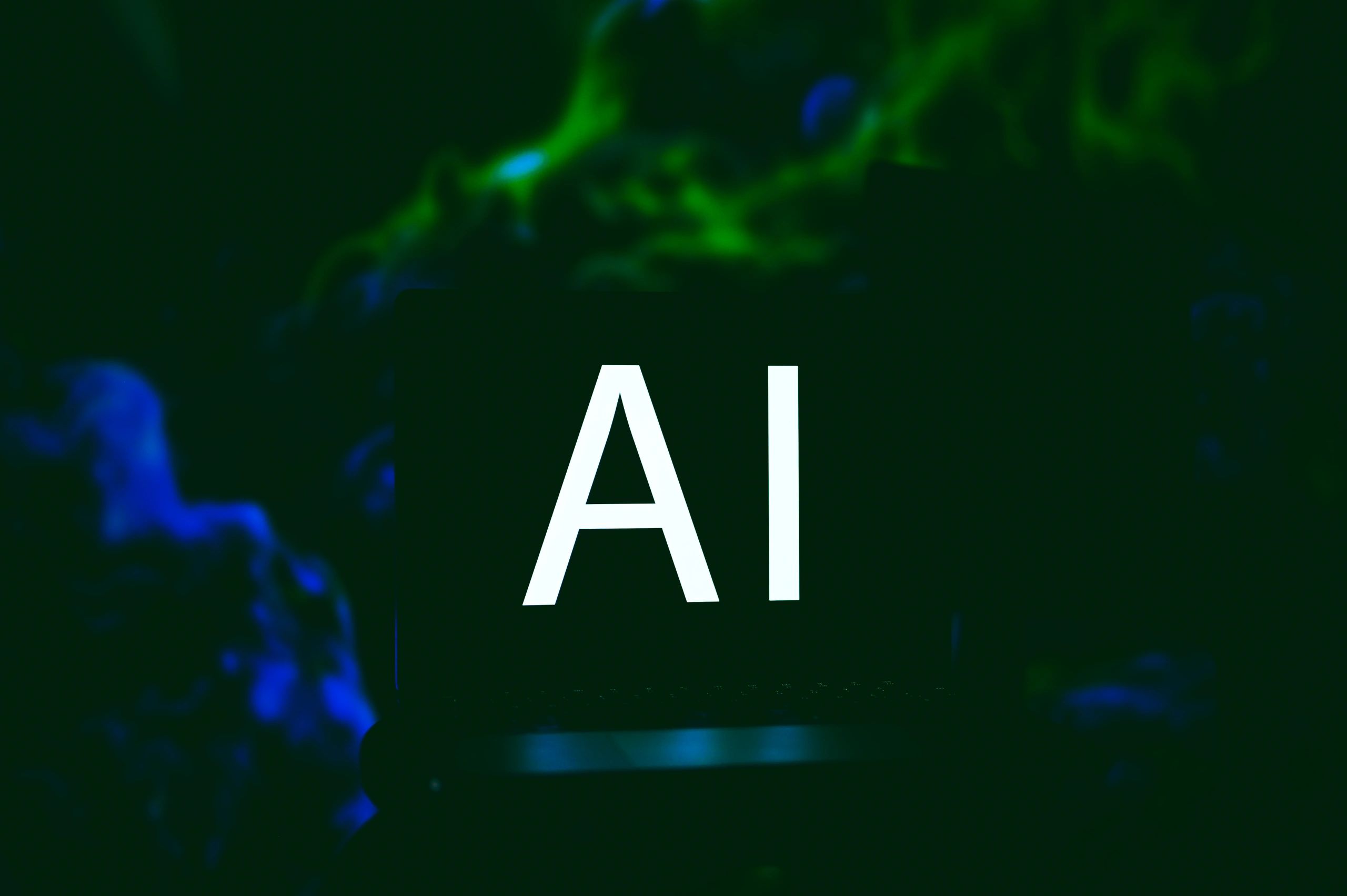 Team collaborating on laptops with AI diagrams